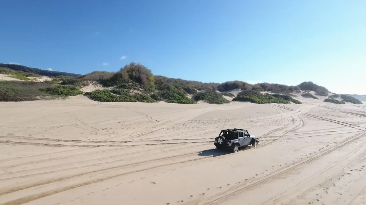 Jeep crossing a bright beach in Grupo Rica's Stay Cool commercial